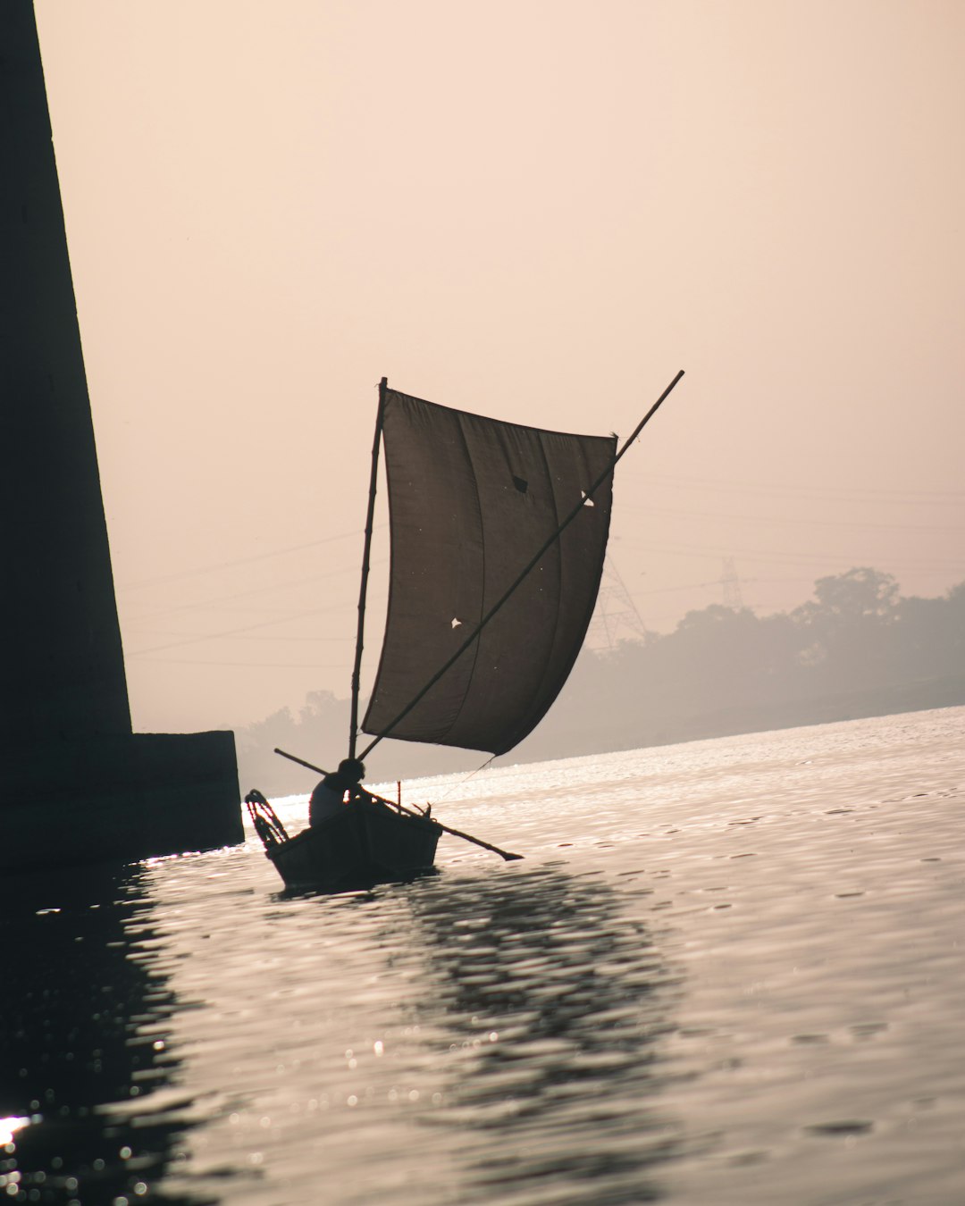 a small boat with a sail on a body of water
